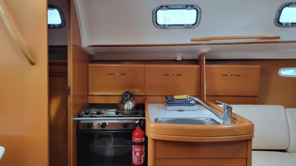 Intérieur d'un voilier de location 2 cabines en Bretagne, avec table à cartes, salle d'eau et cabine arrière