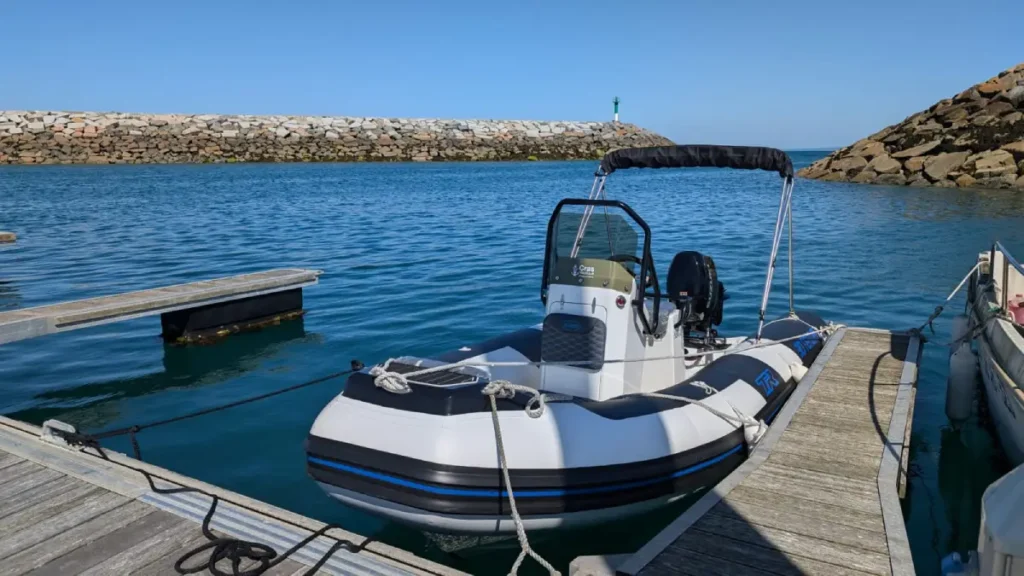 bateau moteur à quai avec vue sur l'entrée du port de Saint Quay Portrieux
